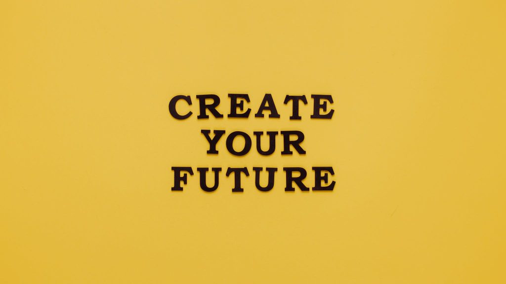 Bold text 'CREATE YOUR FUTURE' on minimalist yellow background. Inspiring design.